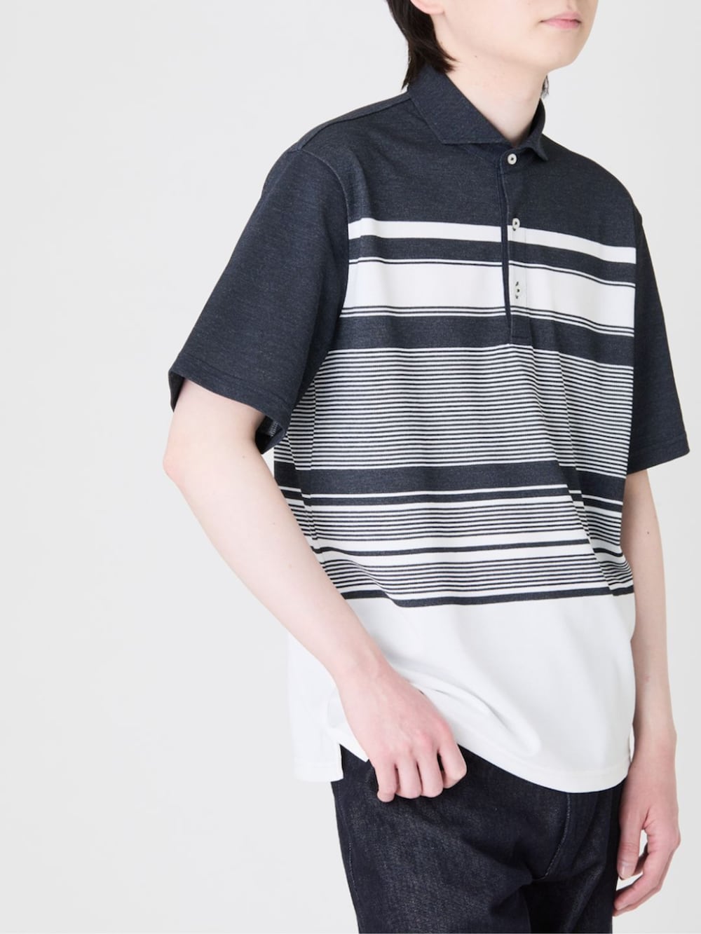 ブルー系のデニムパンツ、ブルー系のポロシャツ、グレー系のスニーカーを着用したメンズの夏コーディネートの4枚目の写真