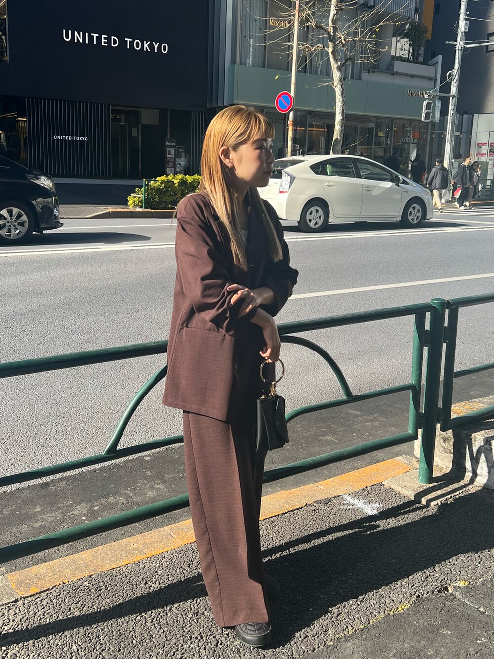 ブラウン系のテーラードジャケット、ブラウン系のその他パンツ、ブラック系のショルダーバッグを着用したレディースの冬コーディネートの4枚目の写真