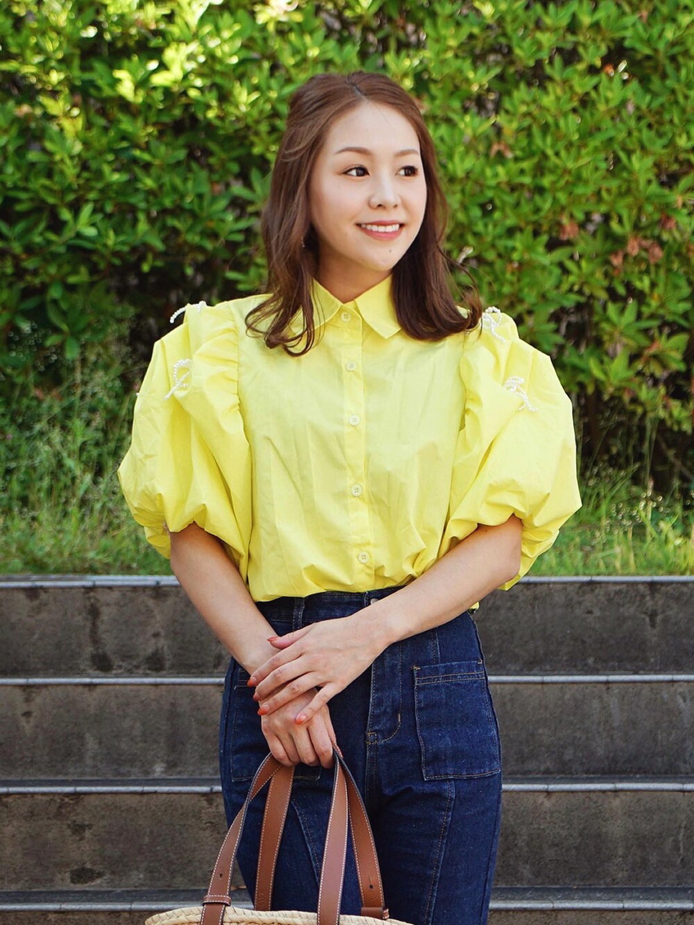 ベージュ系のかごバッグ、イエロー系のシャツ/ブラウスを着用したレディースの夏コーディネートの3枚目の写真