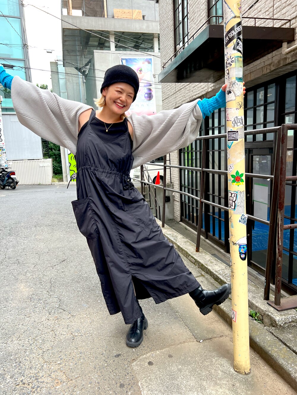 ブラック系のワンピース、グレー系のカーディガン/ボレロ、ブラック系のブーツを着用したレディースの夏コーディネートの3枚目の写真