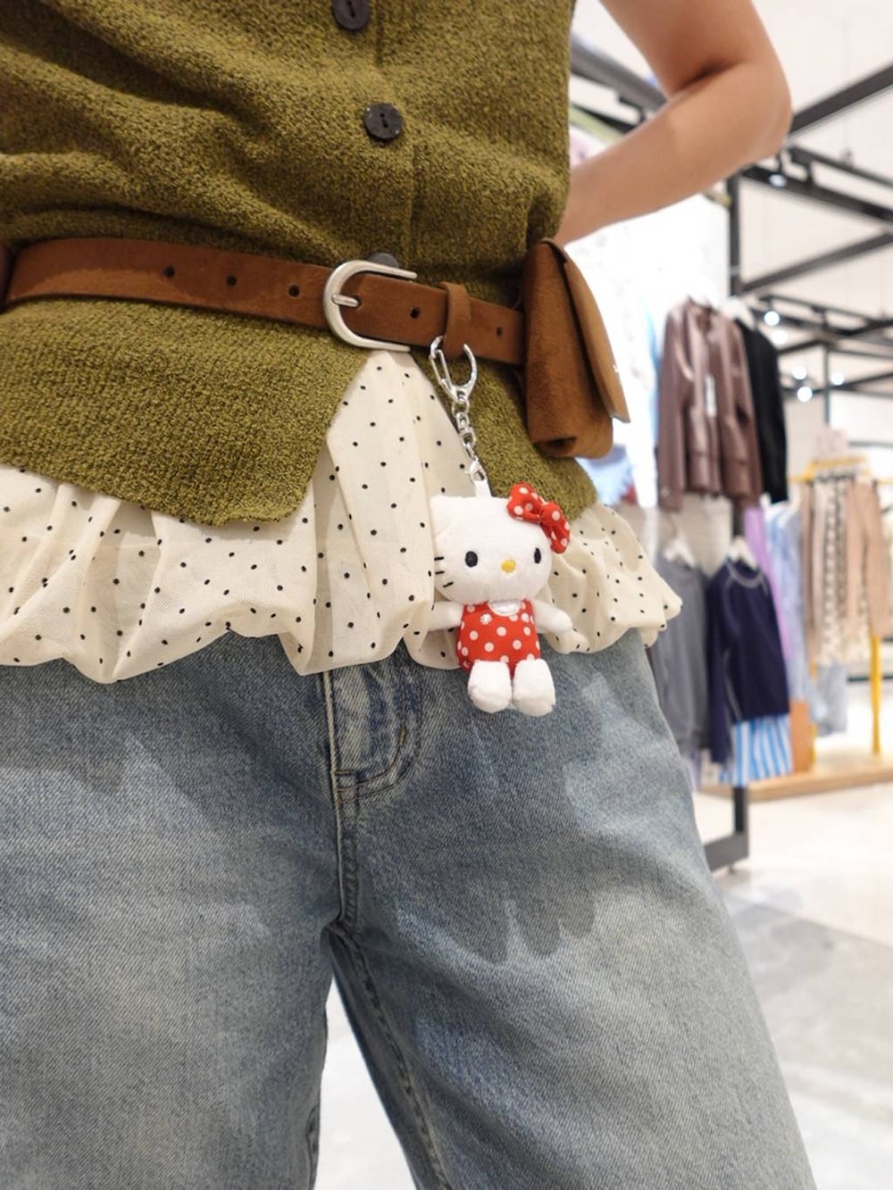 グリーン系のベスト、ブルー系のデニムパンツ、ブラウン系のサンダルを着用したレディースの夏コーディネートの6枚目の写真