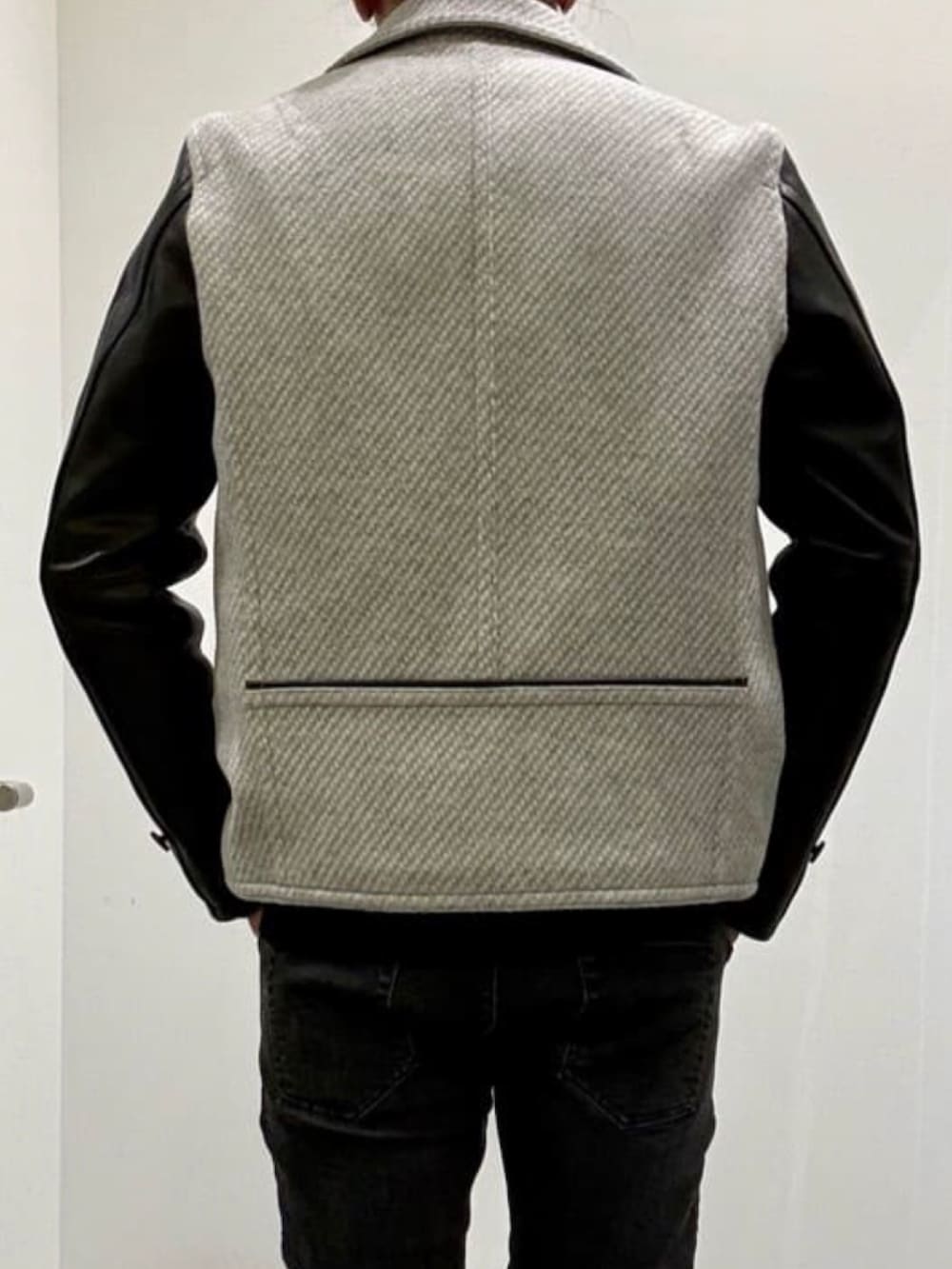 ブラック系のブーツ、ブラック系のデニムパンツ、グレー系のピーコートを着用したメンズの夏コーディネートの6枚目の写真