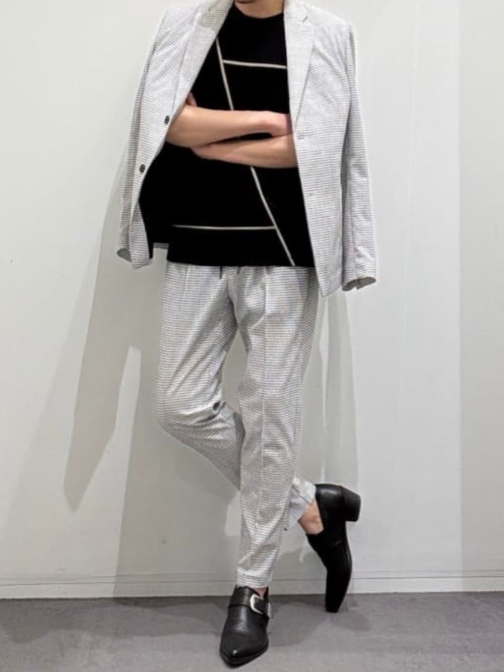 ブラック系のスリッポン、ホワイト系のスラックス、ブラック系のTシャツ/カットソーを着用したメンズの夏コーディネートの4枚目の写真