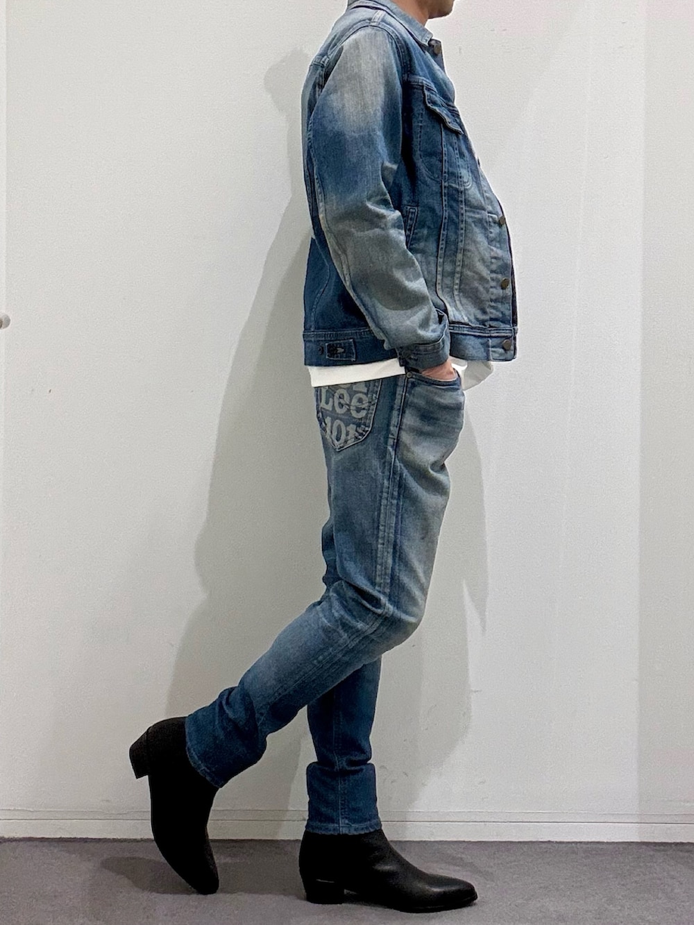 ブルー系のデニムジャケット、ブルー系のデニムパンツ、ブラック系のブーツを着用したメンズの春コーディネートの5枚目の写真