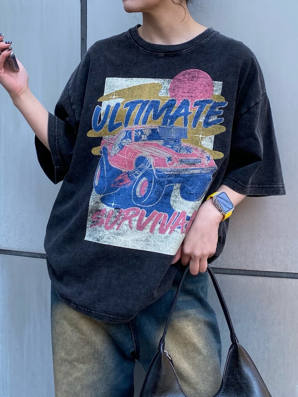 ブラック系のTシャツ/カットソー、ブルー系のデニムパンツを着用したレディースの春コーディネートの2枚目の写真