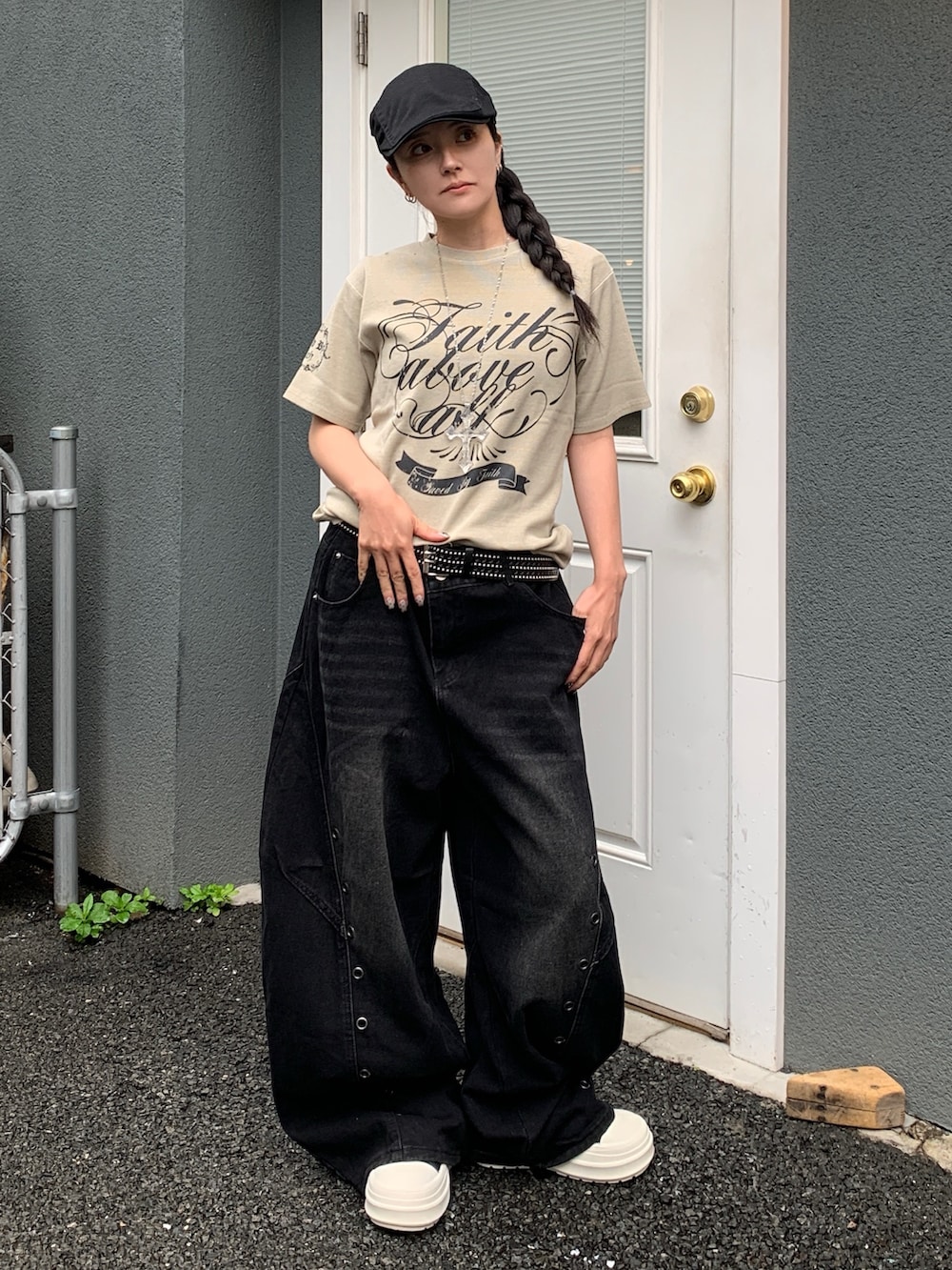 グレー系のTシャツ/カットソー、ブラック系のデニムパンツ、ブラック系のスニーカーを着用したレディースの春コーディネートの2枚目の写真
