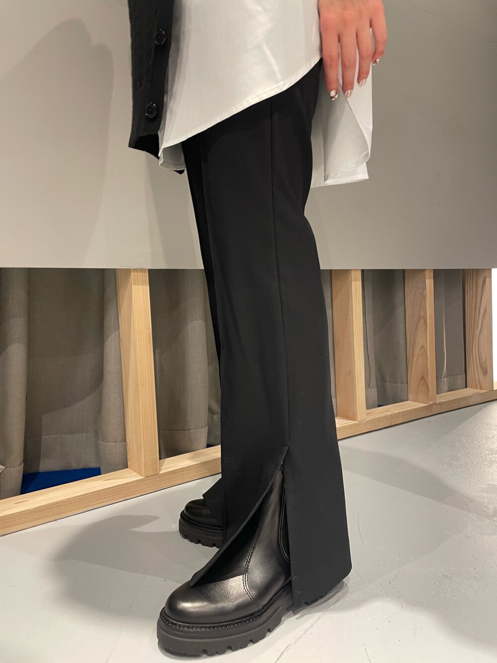 ベージュ系のトレンチコート、ブラック系のニット/セーター、ブラック系のパンツを着用したレディースの冬コーディネートの5枚目の写真