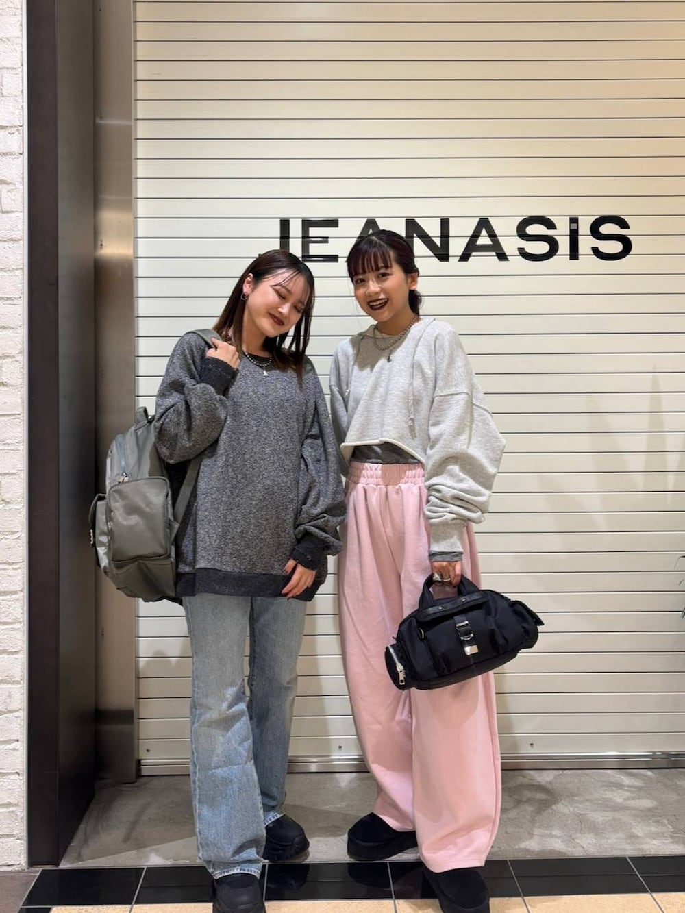 ブラック系のブーツ、ブラック系のスウェット、グリーン系のバックパック/リュックを着用したレディースの冬コーディネートの3枚目の写真