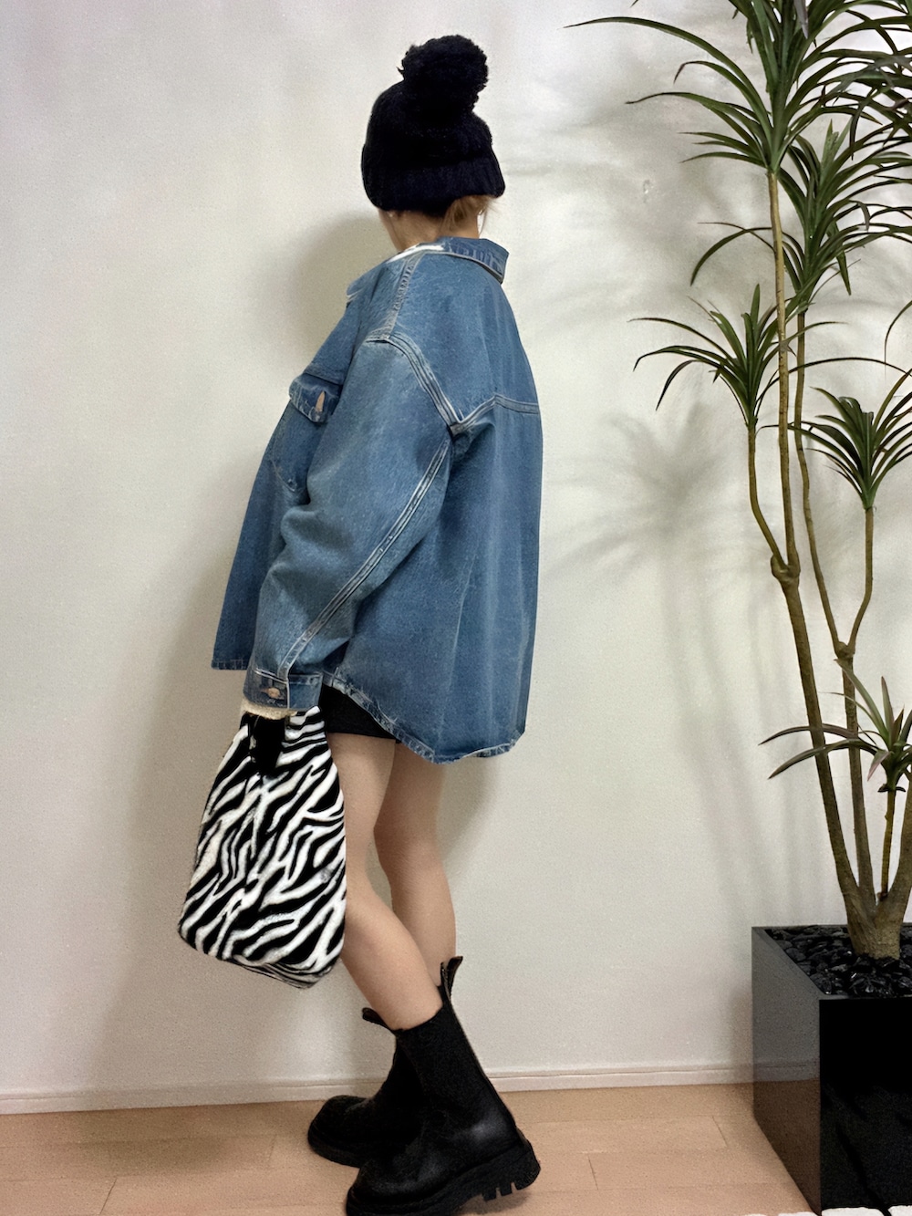 グリーン系のスウェット、ブルー系のデニムジャケット、ブラック系のパンツを着用したレディースの秋コーディネートの3枚目の写真