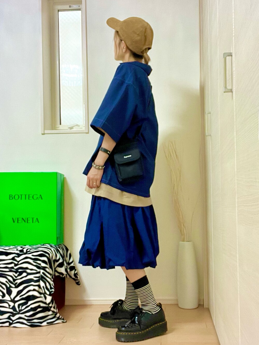 ブルー系のスカート、ブラック系のローファー、ブルー系のシャツ/ブラウスを着用したレディースの夏コーディネートの2枚目の写真