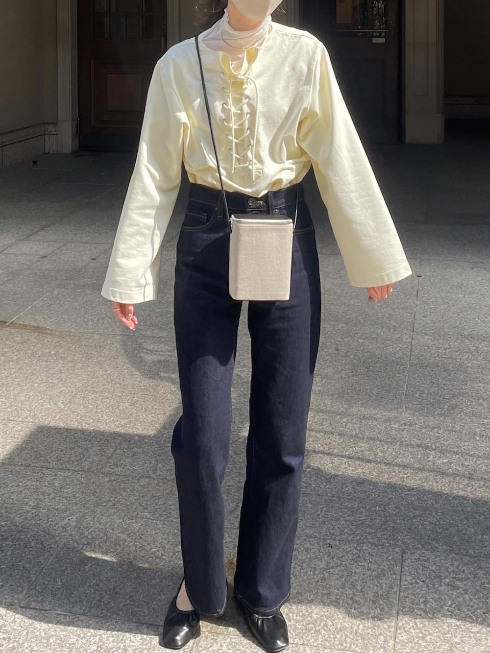 ホワイト系のTシャツ/カットソー、グレー系のショルダーバッグ、ブルー系のデニムパンツを着用したレディースの春コーディネートの2枚目の写真