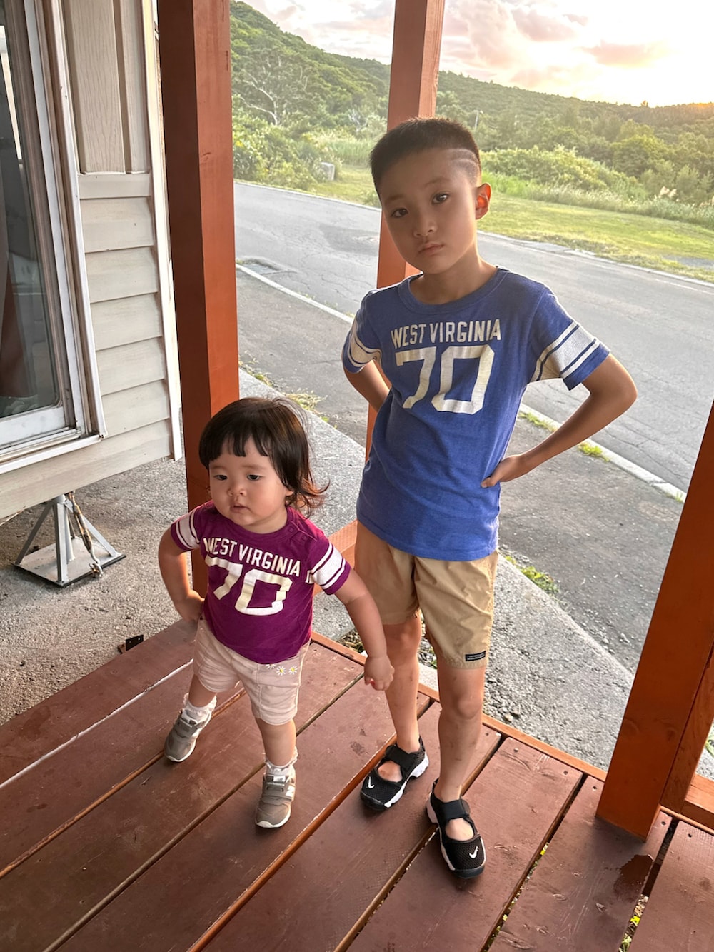 ブルー系のTシャツ/カットソー、ベージュ系のその他パンツ、ブラック系のスニーカーを着用したキッズの秋コーディネートの3枚目の写真
