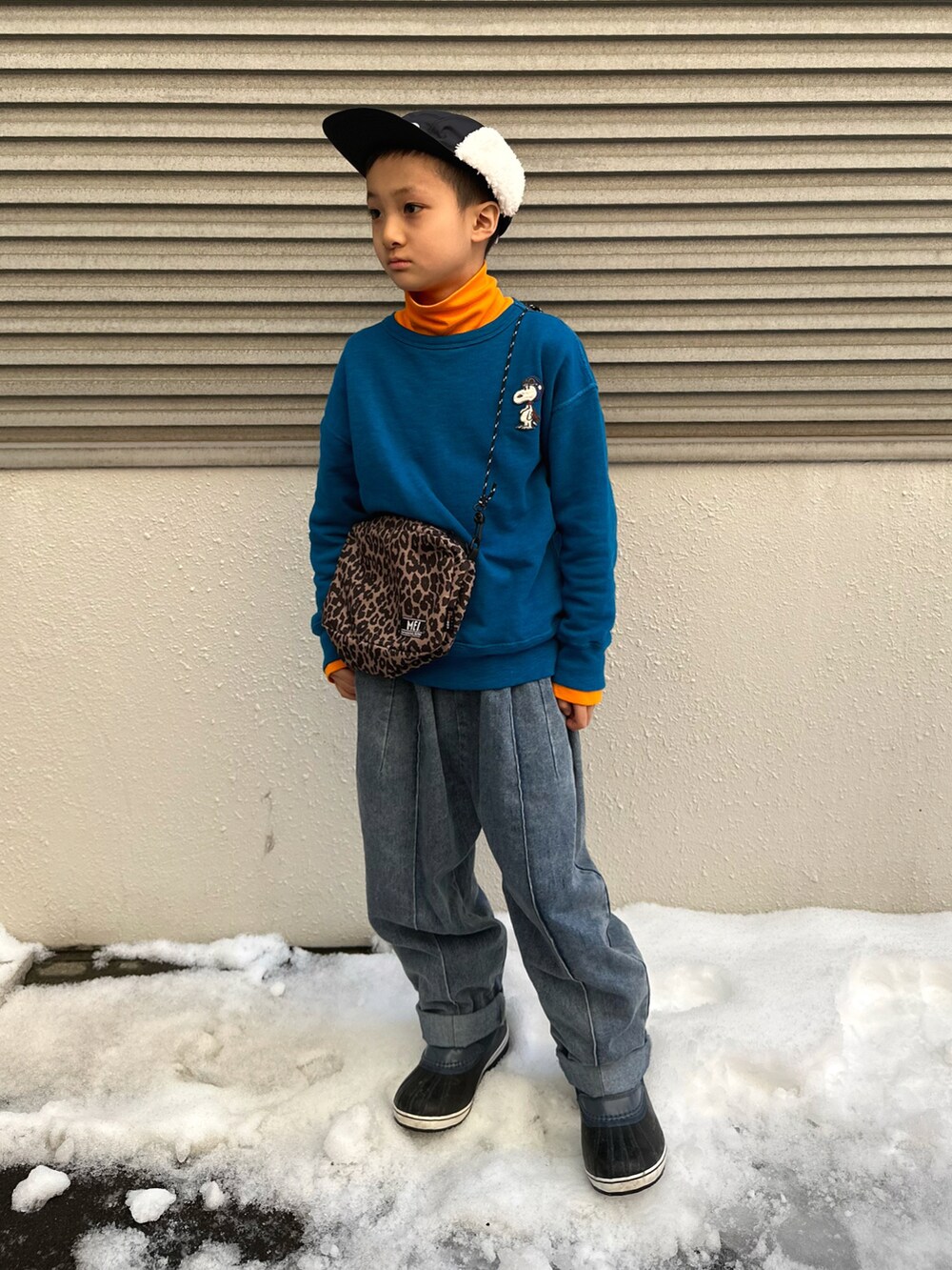 ブルー系のスウェット、オレンジ系のTシャツ/カットソー、ブルー系のデニムパンツを着用したキッズの春コーディネートの2枚目の写真