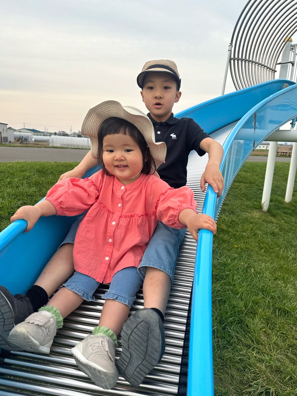 ピンク系のシャツ/ブラウス、ホワイト系のサンダル、ベージュ系のハットを着用したキッズの春コーディネートの5枚目の写真