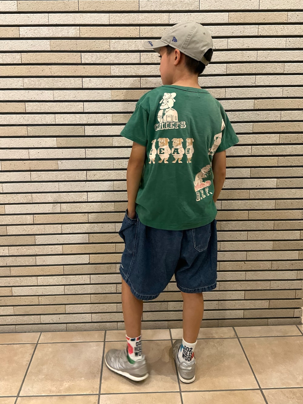グリーン系のTシャツ/カットソー、ブルー系のデニムパンツ、シルバー系のスニーカーを着用したキッズの夏コーディネートの2枚目の写真