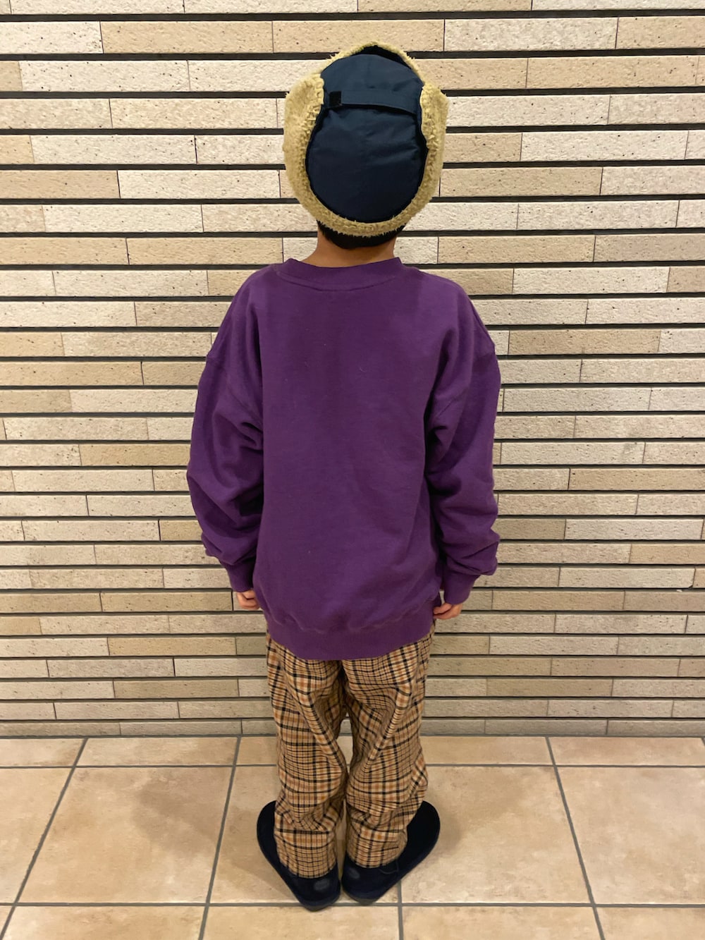 パープル系のスウェット、ブルー系のその他パンツ、ブルー系のブーツを着用したキッズの冬コーディネートの3枚目の写真
