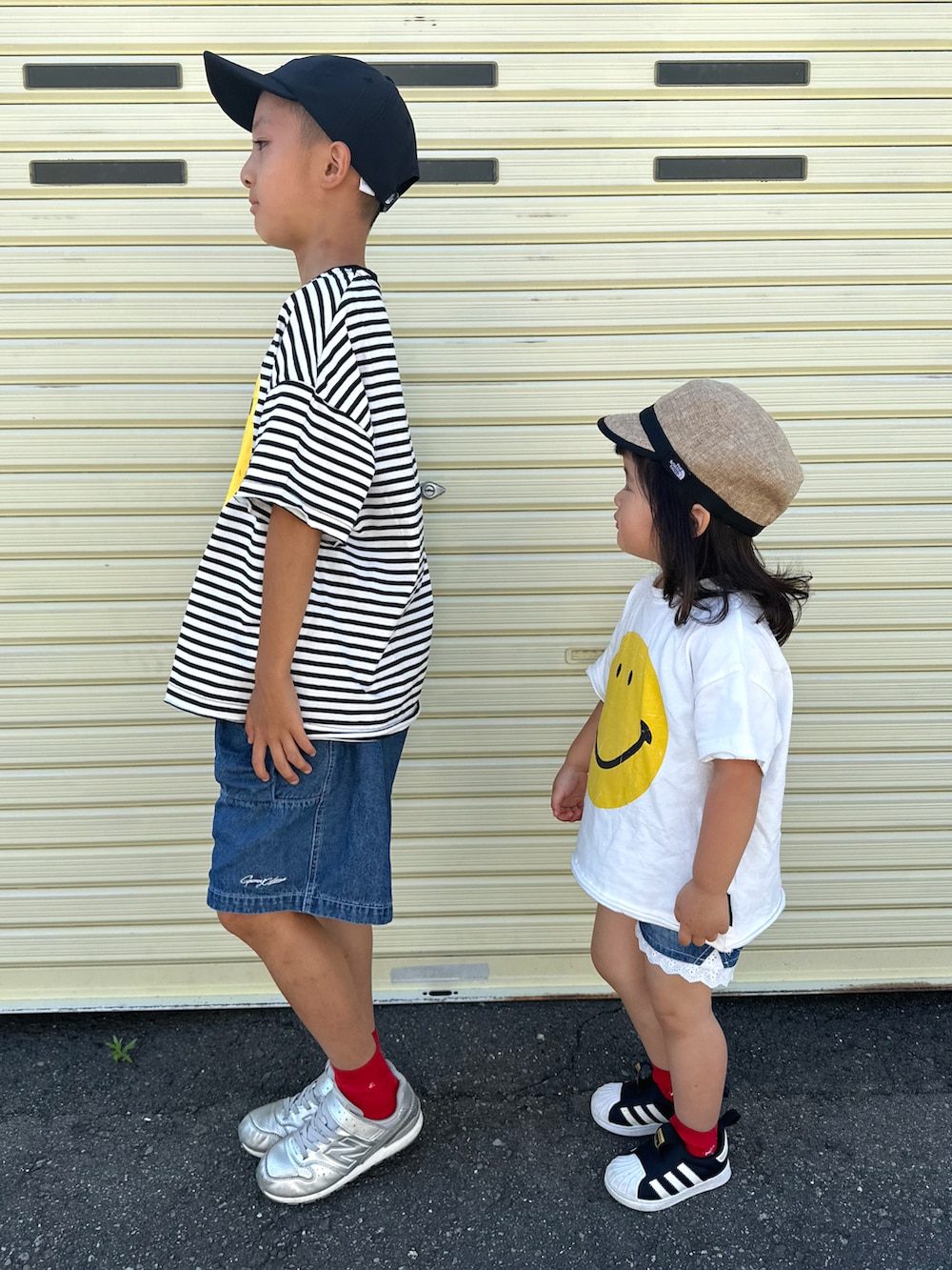 ブラック系のTシャツ/カットソー、ブルー系のデニムパンツ、シルバー系のスニーカーを着用したキッズの夏コーディネートの4枚目の写真