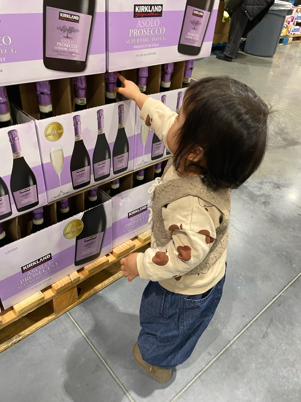 ホワイト系のスウェット、ベージュ系のベスト、ブルー系のデニムパンツを着用したキッズの冬コーディネートの3枚目の写真