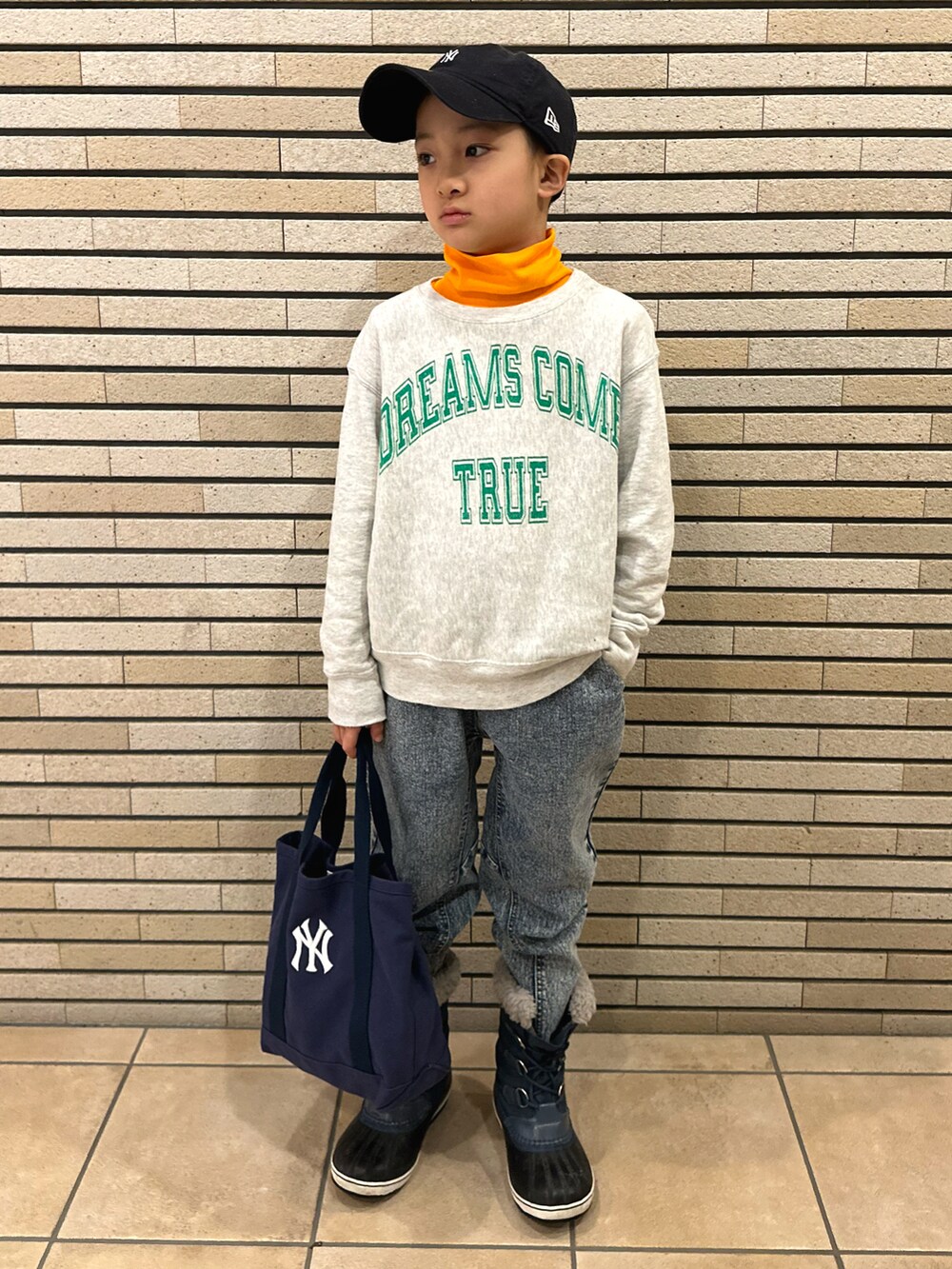 オレンジ系のTシャツ/カットソー、グレー系のスウェット、その他のデニムパンツを着用したキッズの冬コーディネートの2枚目の写真