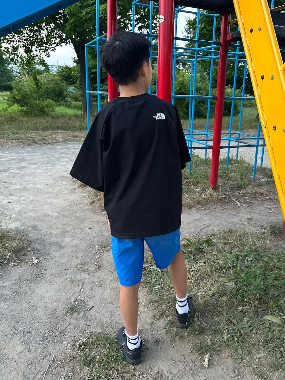 ブラック系のスウェット、ブルー系のその他パンツ、ブラック系のスニーカーを着用したキッズの夏コーディネートの2枚目の写真