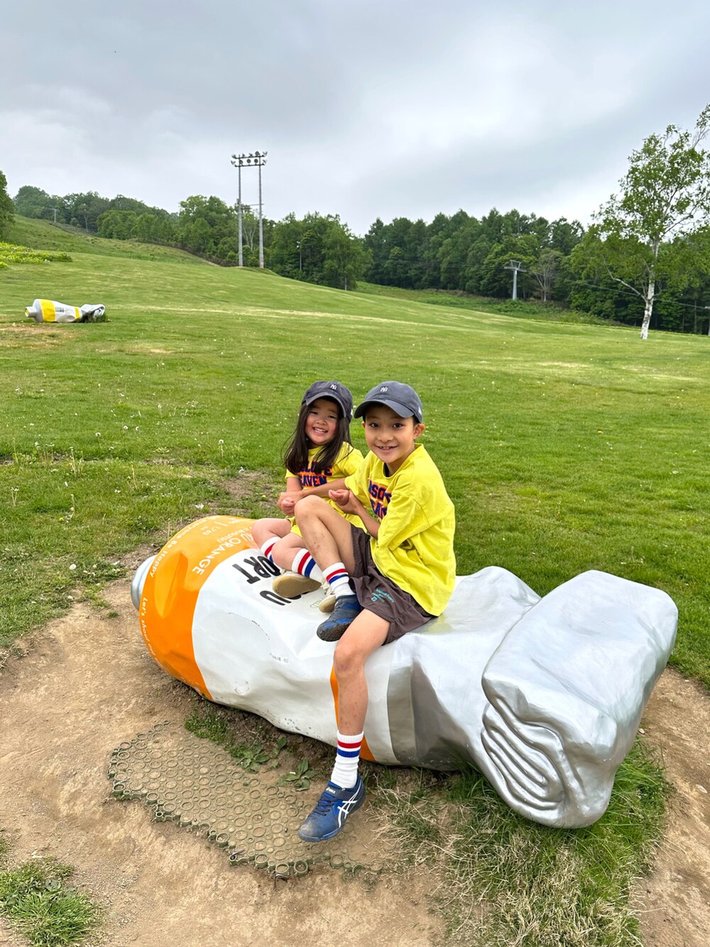 イエロー系のTシャツ/カットソー、イエロー系のワンピース、ブラウン系のパンツを着用したキッズの夏コーディネートの2枚目の写真