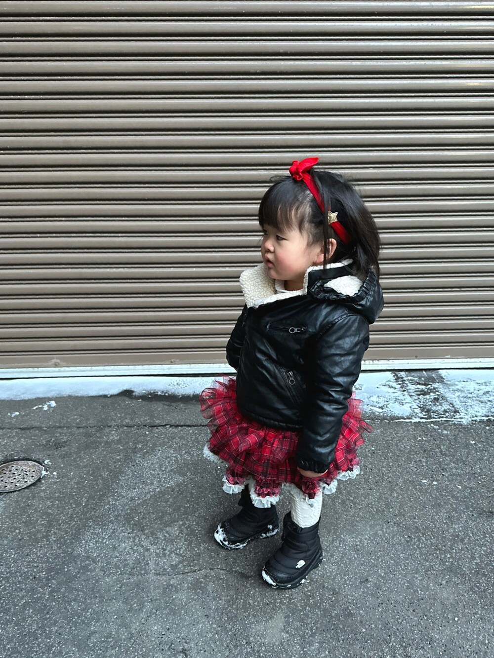 ブラック系のナイロンジャケット、ブルー系のその他アウター、レッド系のその他パンツを着用したキッズの冬コーディネートの5枚目の写真