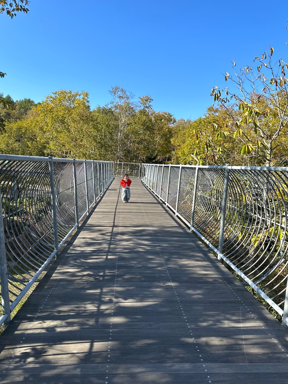 ブルー系のデニムパンツ、ゴールド系のスニーカー、ホワイト系のTシャツ/カットソーを着用したキッズの秋コーディネートの4枚目の写真