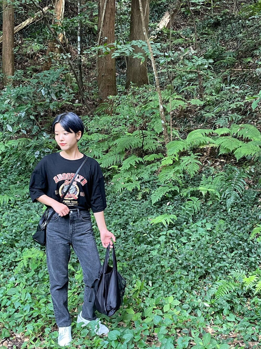 ブラック系のデニムパンツ、ブラック系のTシャツ/カットソーを着用したレディースの秋コーディネートの2枚目の写真