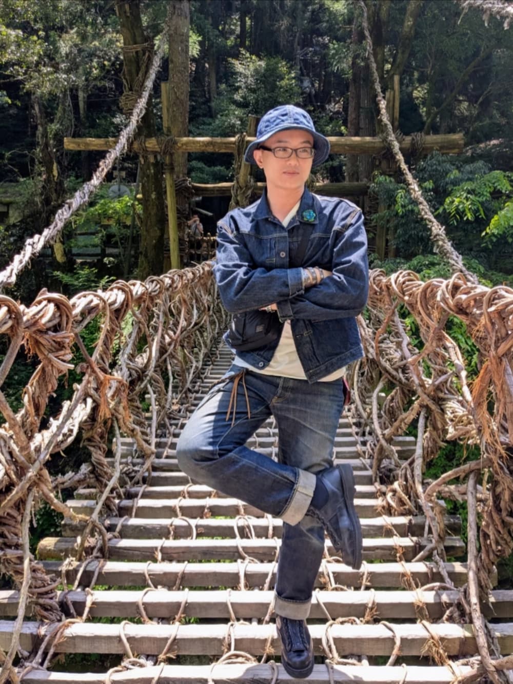 ブラック系のブーツ、ブルー系のデニムパンツ、ブルー系のデニムジャケットを着用したメンズの夏コーディネートの3枚目の写真