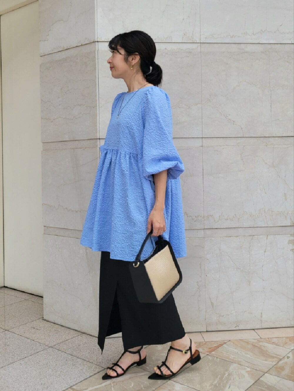 ブルー系のシャツ/ブラウス、ブラック系のスカートを着用したレディースの夏コーディネートの2枚目の写真