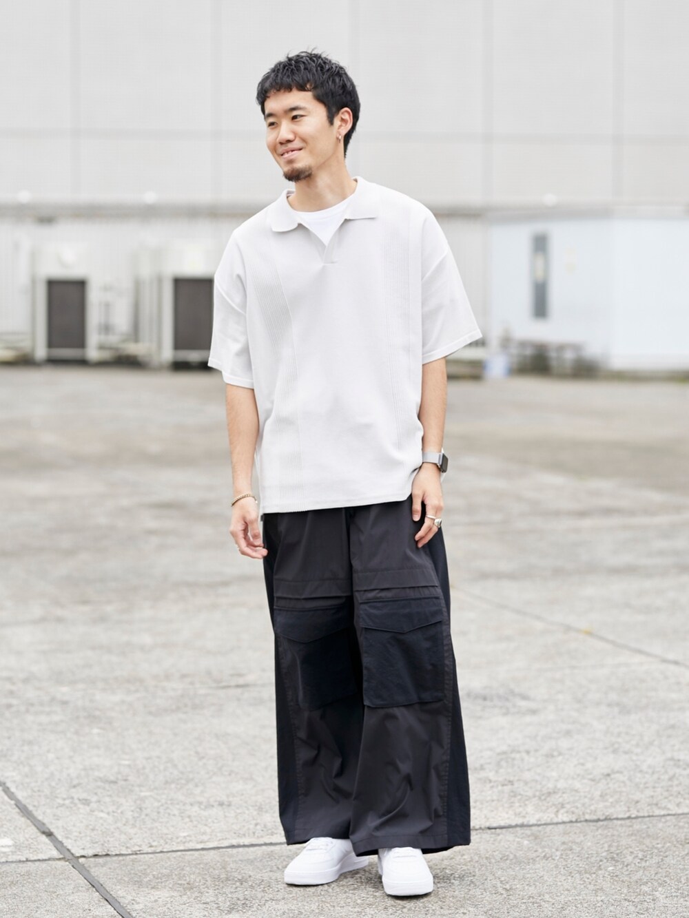 グレー系のポロシャツ、ブラック系のカーゴパンツを着用したメンズの春コーディネートの5枚目の写真