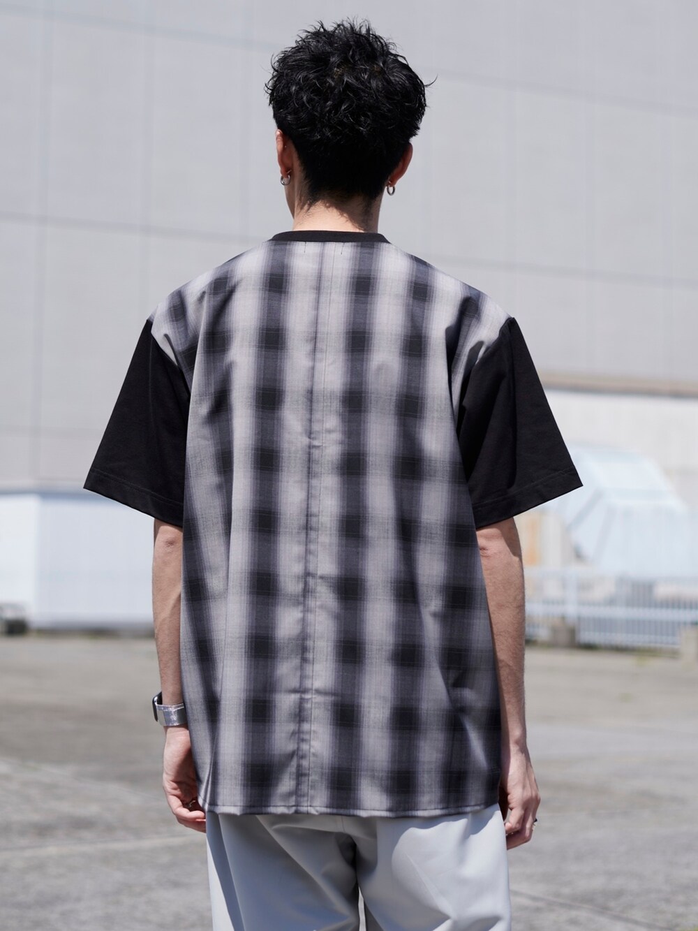 ブラック系のTシャツ/カットソー、グレー系のカーゴパンツを着用したメンズの春コーディネートの2枚目の写真