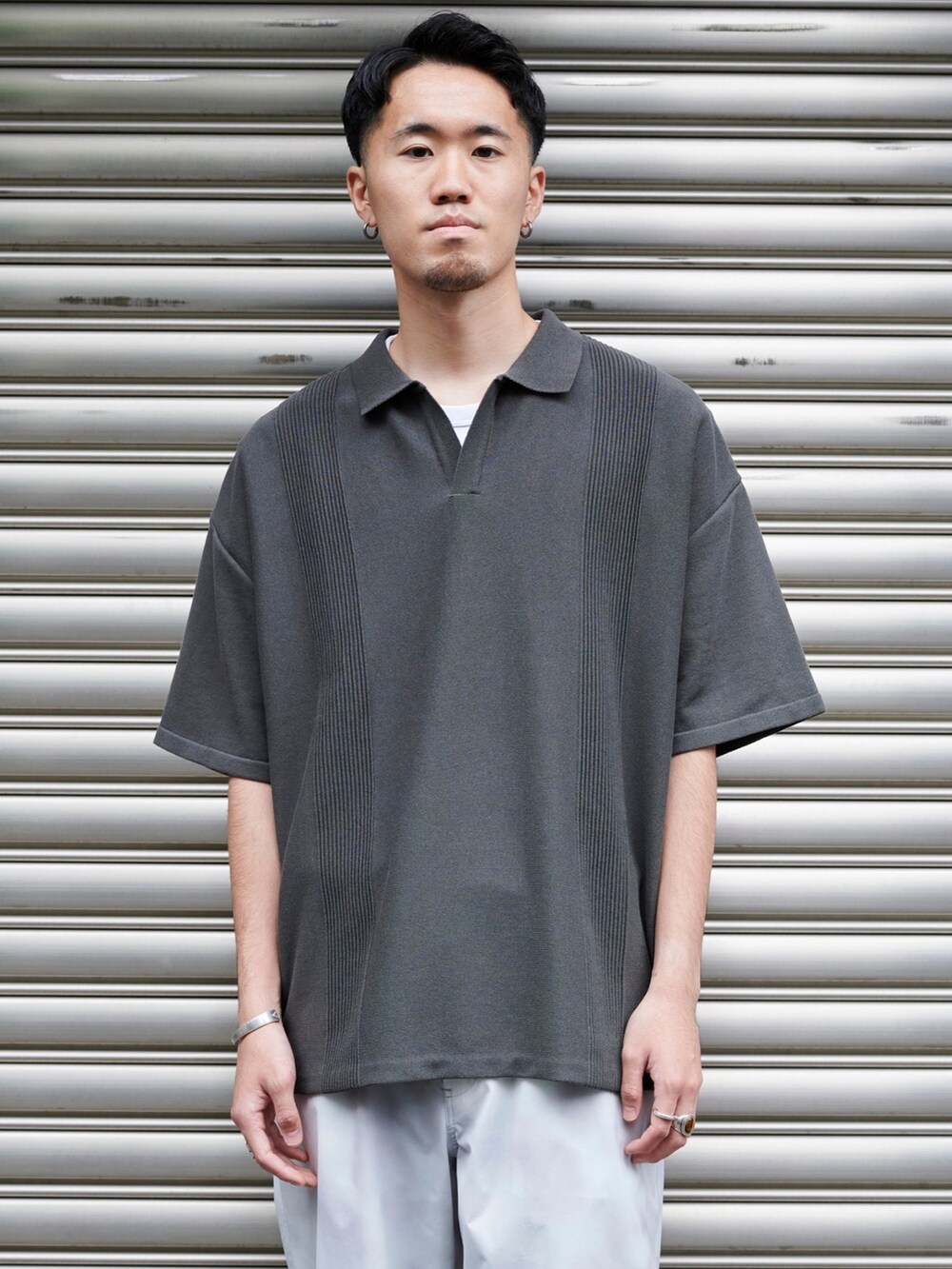 グレー系のポロシャツを着用したメンズの夏コーディネートの4枚目の写真