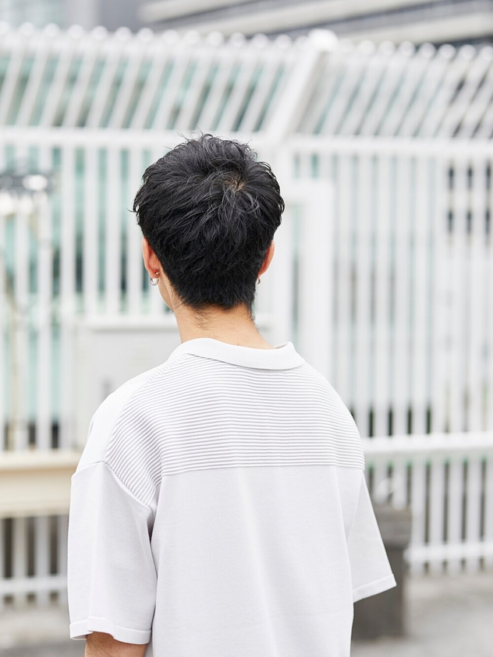 グレー系のポロシャツ、ブラック系のカーゴパンツを着用したメンズの春コーディネートの4枚目の写真