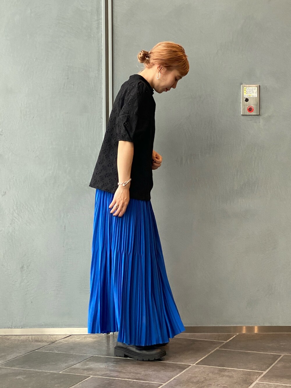 ブラック系のTシャツ/カットソー、ブルー系のスカートを着用したレディースの夏コーディネートの2枚目の写真