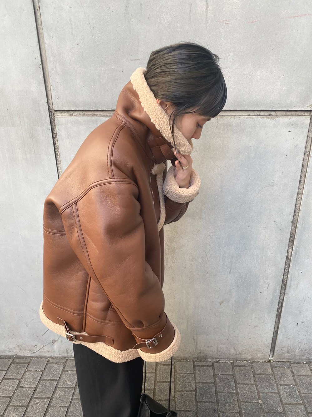 ブラウン系のミリタリージャケットを着用したレディースの冬コーディネートの3枚目の写真