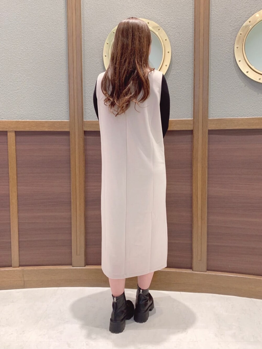 ベージュ系のワンピース、ホワイト系のショルダーバッグ、ブラック系のニット/セーターを着用したレディースの春コーディネートの3枚目の写真