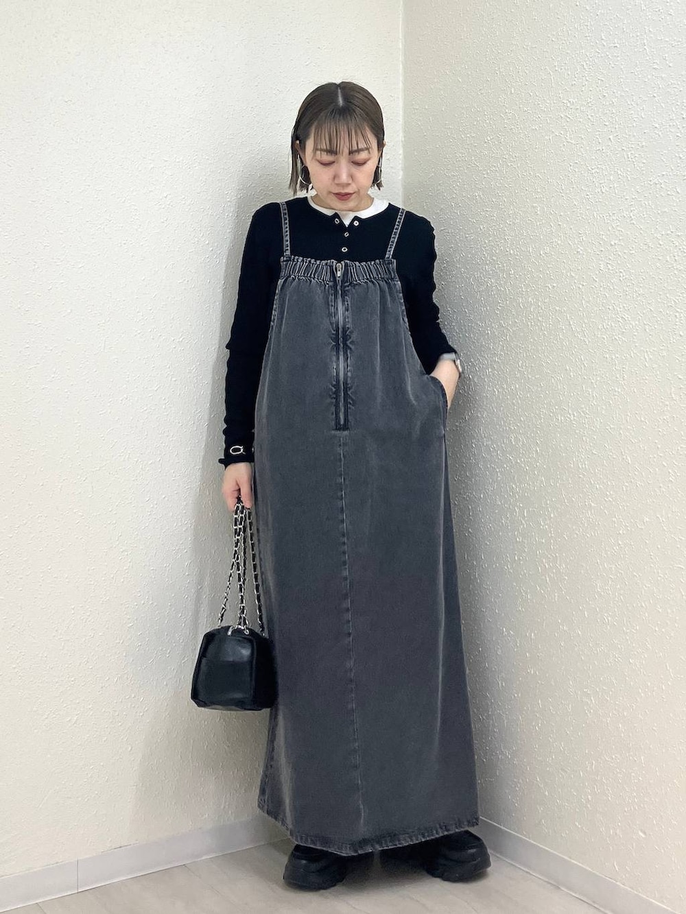 ブラック系のニット/セーター、ブラック系のショルダーバッグ、ブラック系のローファーを着用したレディースの冬コーディネートの6枚目の写真