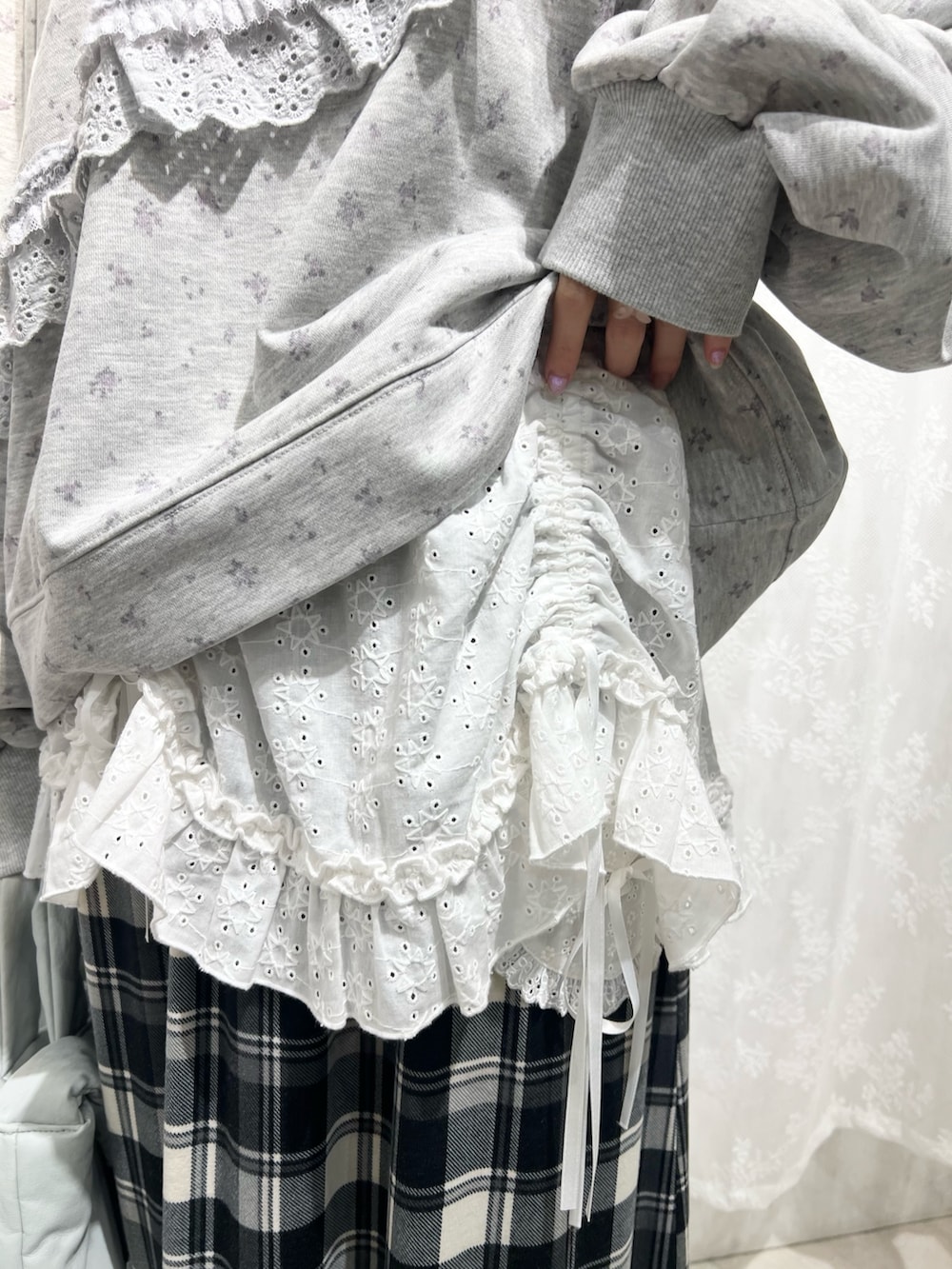 グレー系のスウェット、ベージュ系のスカート、ブラック系のスニーカーを着用したレディースの冬コーディネートの8枚目の写真