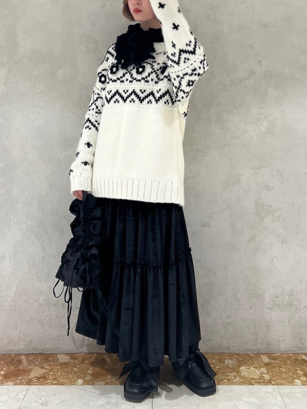 ホワイト系のニット/セーター、ブラック系のショルダーバッグ、ブラック系のモカシン/デッキシューズを着用したレディースの冬コーディネートの5枚目の写真