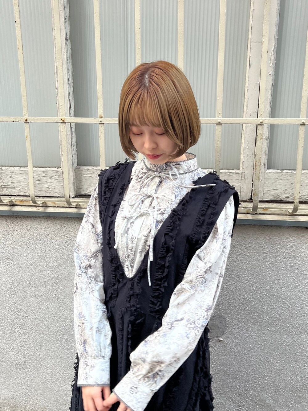 グレー系のシャツ/ブラウス、ブラック系のワンピース、ブラック系のブーツを着用したレディースの秋コーディネートの5枚目の写真