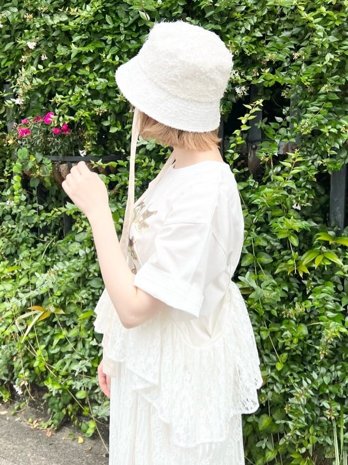 オレンジ系のパンプス、ホワイト系のスカート、ベージュ系のTシャツ/カットソーを着用したレディースの夏コーディネートの5枚目の写真