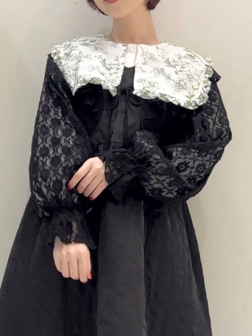 ブラック系のワンピース、ブラック系のカーディガン/ボレロ、ブラック系のスニーカーを着用したレディースの冬コーディネートの9枚目の写真