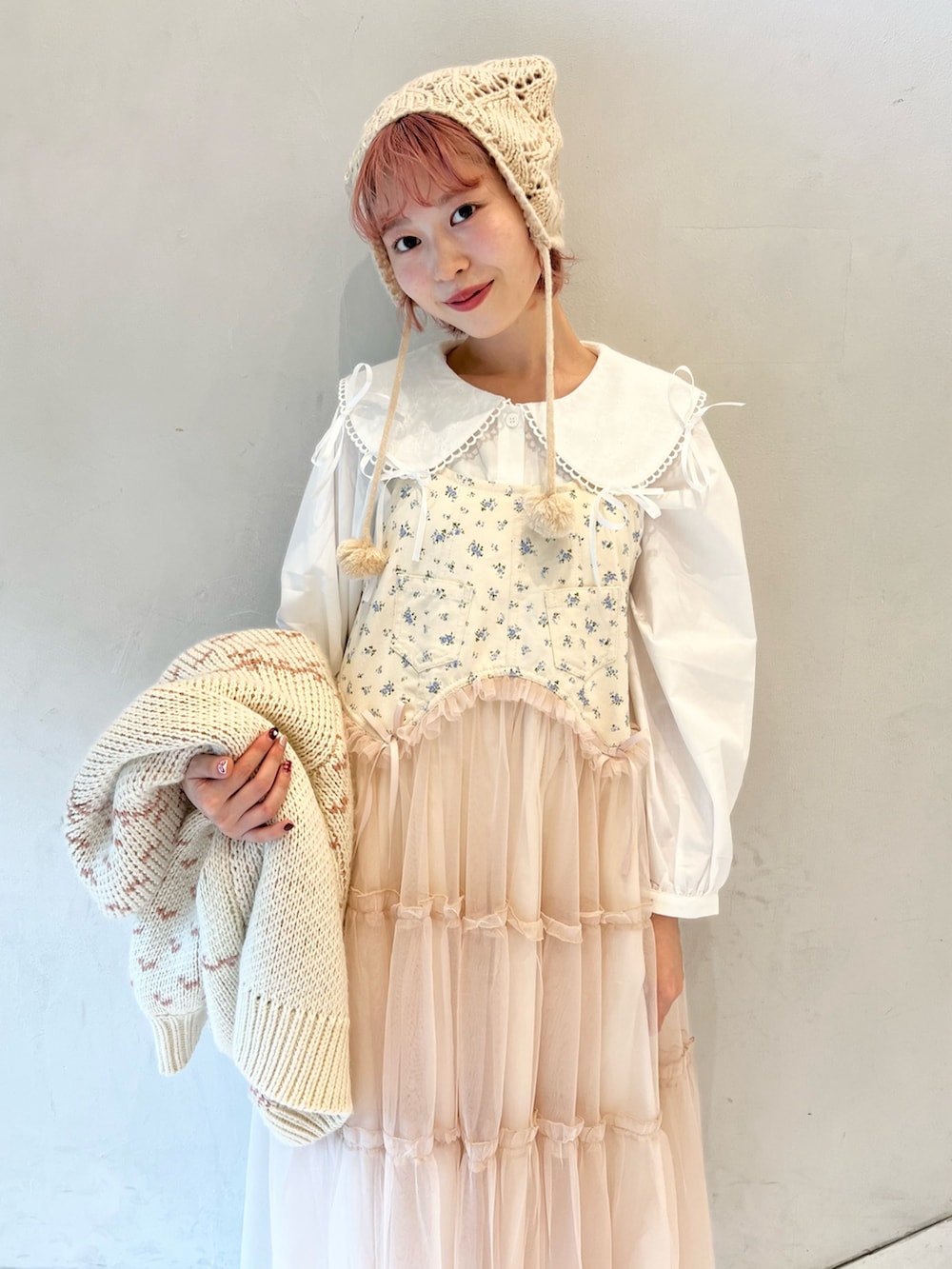 ピンク系のカーディガン/ボレロ、ホワイト系のシャツ/ブラウス、ピンク系のワンピースを着用したレディースの冬コーディネートの9枚目の写真