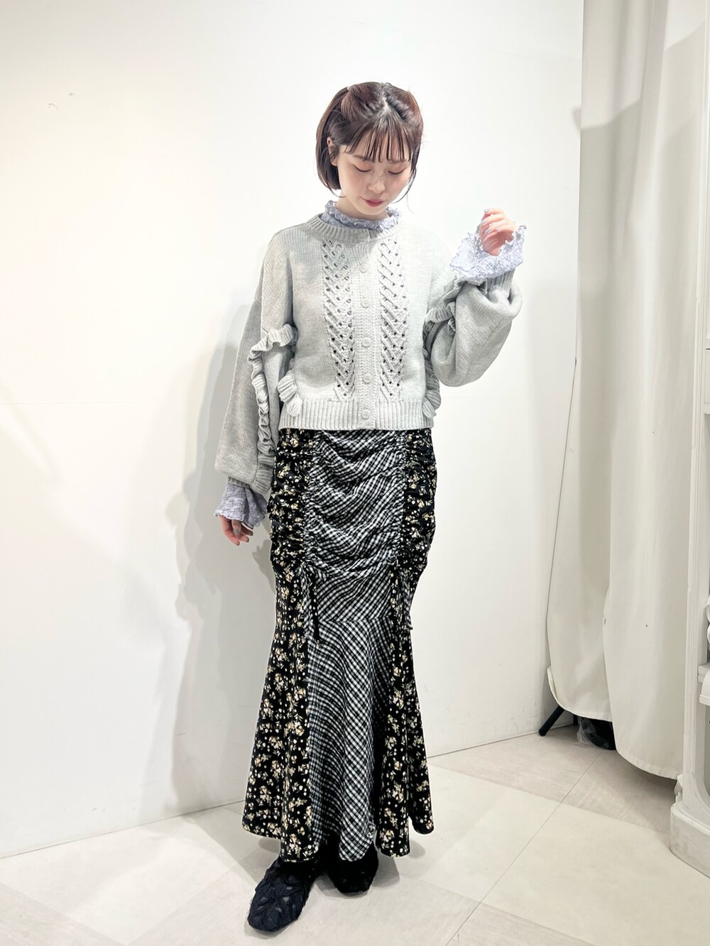 グレー系のカーディガン/ボレロ、ブルー系のTシャツ/カットソー、ブラック系のスカートを着用したレディースの秋コーディネートの4枚目の写真