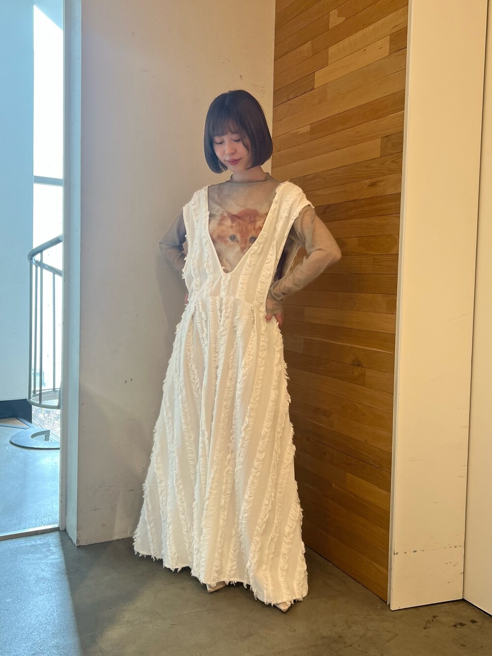 ホワイト系のワンピース、ベージュ系のTシャツ/カットソー、ベージュ系のパンプスを着用したレディースの春コーディネートの2枚目の写真