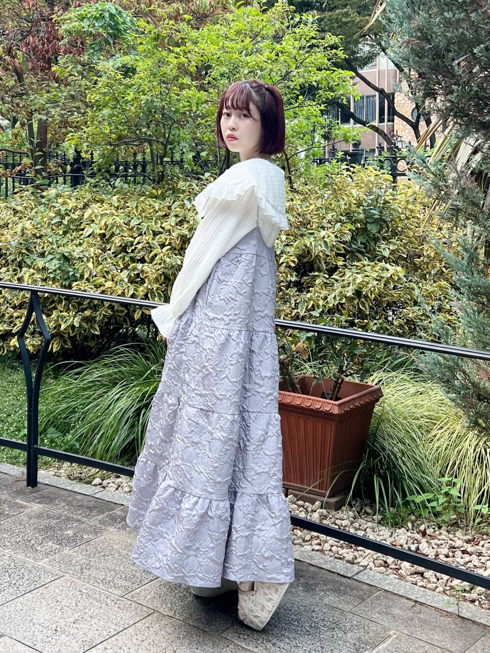 ホワイト系のシャツ/ブラウス、パープル系のワンピース、ホワイト系のサンダルを着用したレディースの秋コーディネートの3枚目の写真