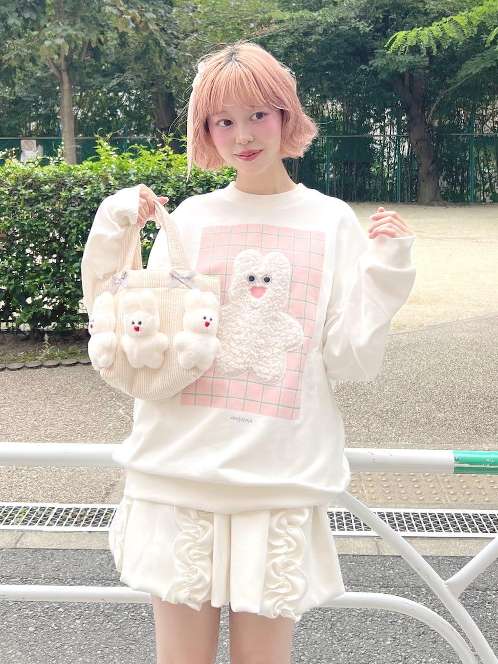 ホワイト系のスカート、ピンク系のブーツ、ホワイト系のスウェットを着用したレディースの秋コーディネートの8枚目の写真