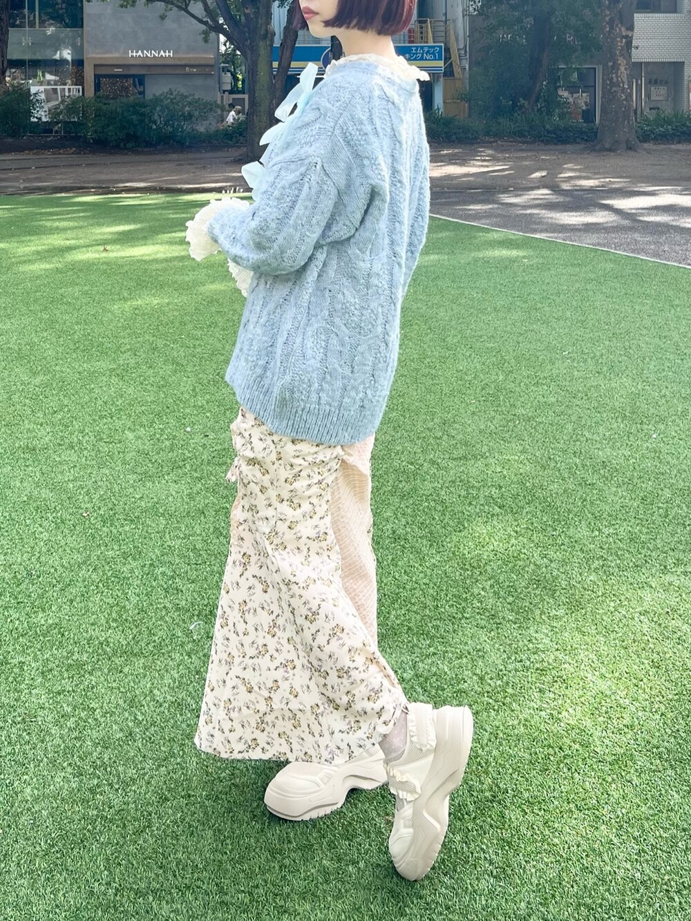 ブルー系のニット/セーター、ホワイト系のTシャツ/カットソー、ホワイト系のスカートを着用したレディースの秋コーディネートの4枚目の写真