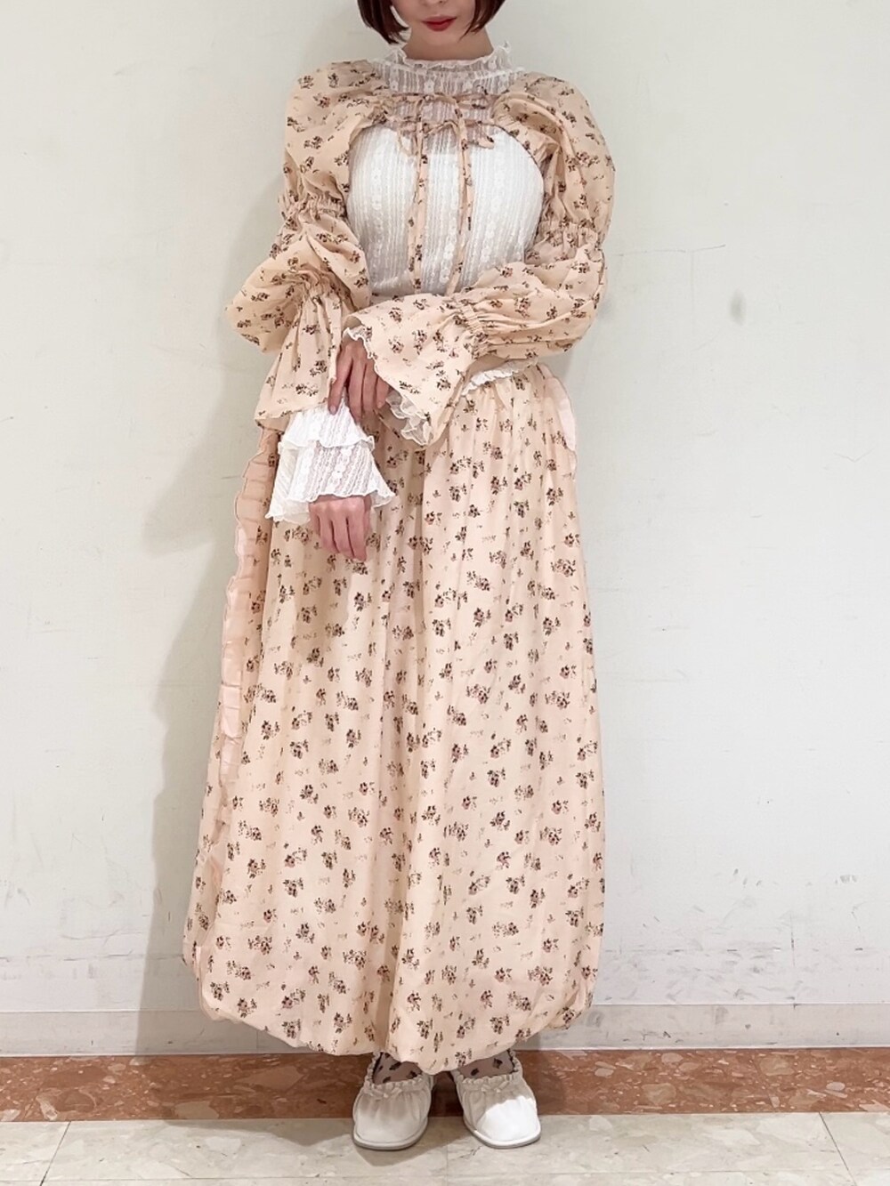 ピンク系のスカート、ピンク系のカーディガン/ボレロ、ホワイト系のパンプスを着用したレディースの春コーディネートの4枚目の写真